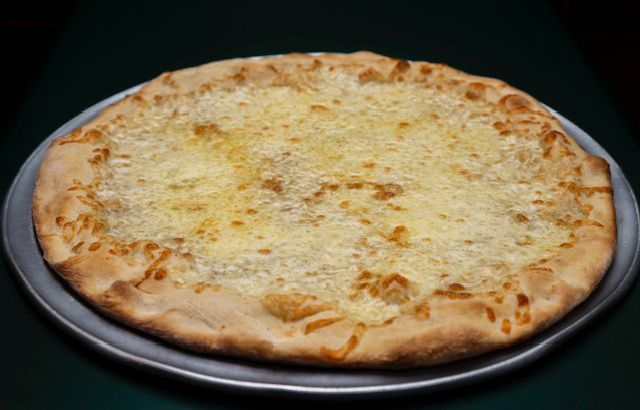 Cheese pizza on a metal pizza pan, crust is golden brown with melted cheese.