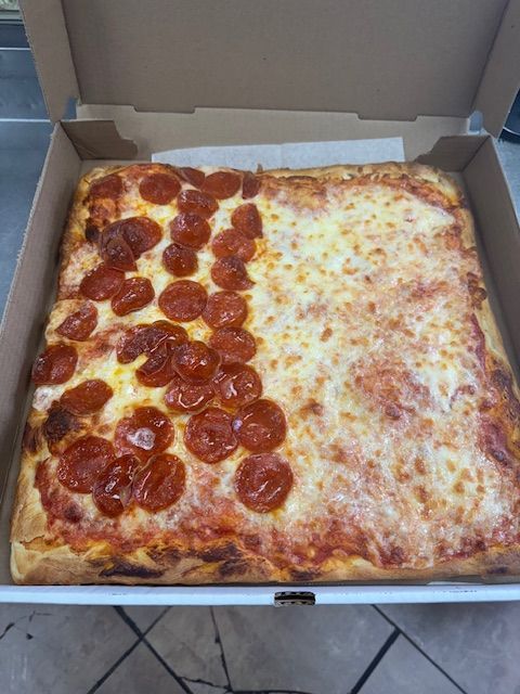Square pizza in a box, half pepperoni, half cheese.