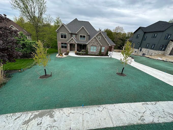 A large house with a green lawn in front of it.