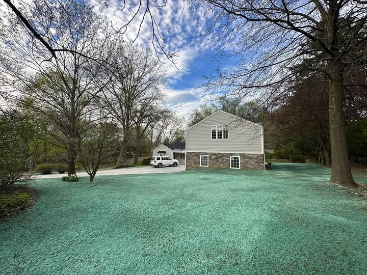 A house with a lot of green grass in front of it.