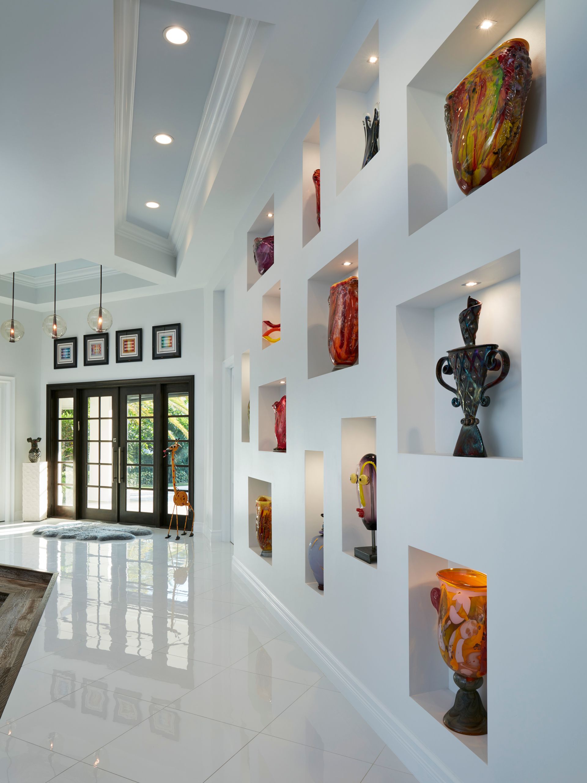A hallway with a lot of vases on the wall