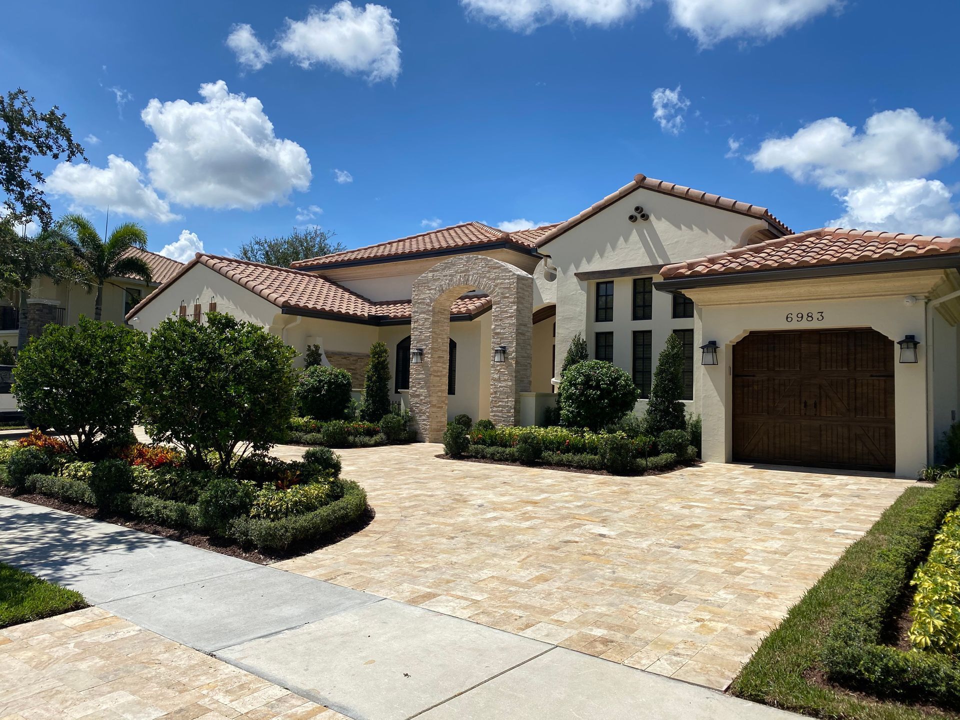 A large white house with a brown garage door