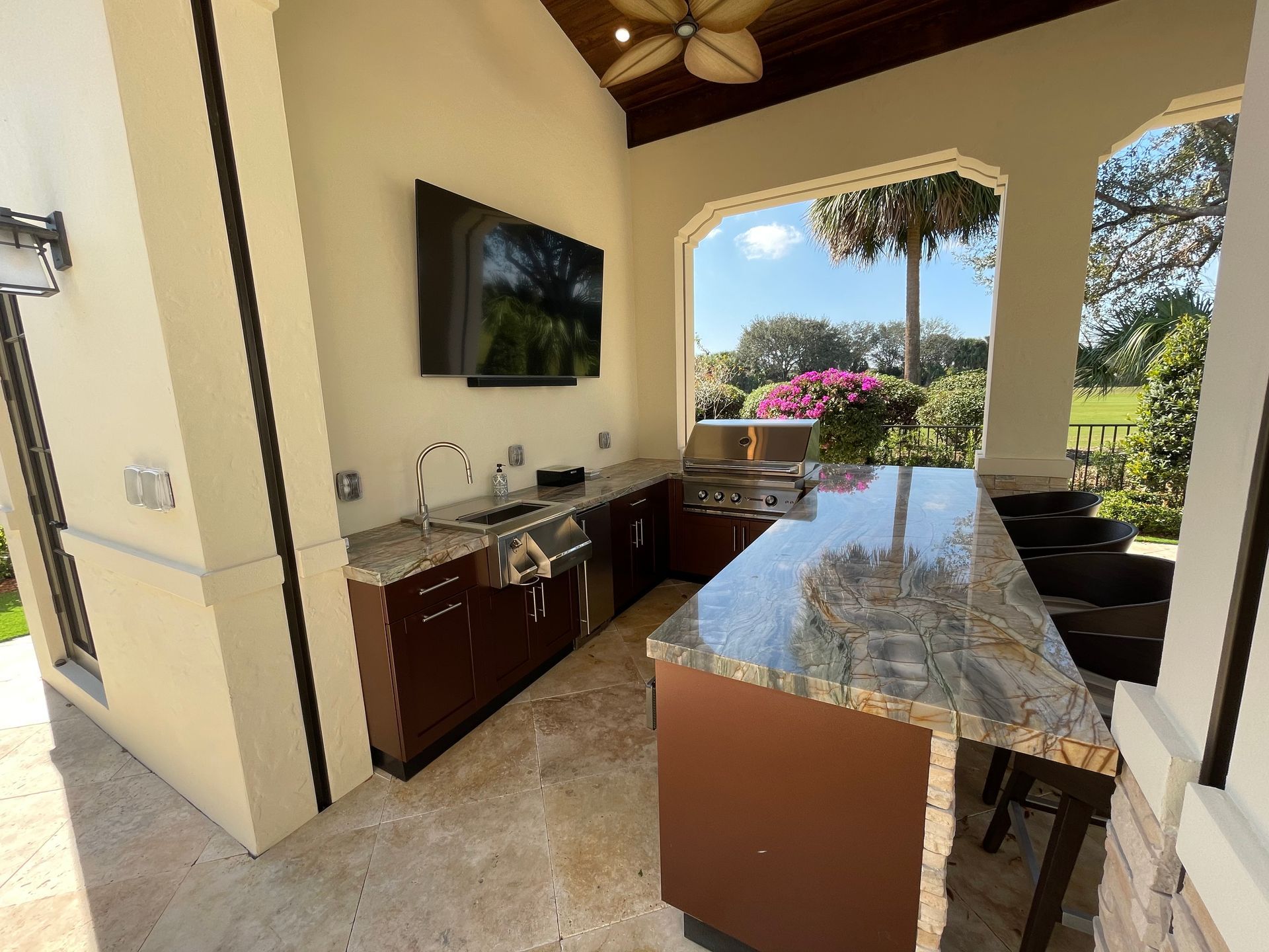 A kitchen with a large island and a television on the wall