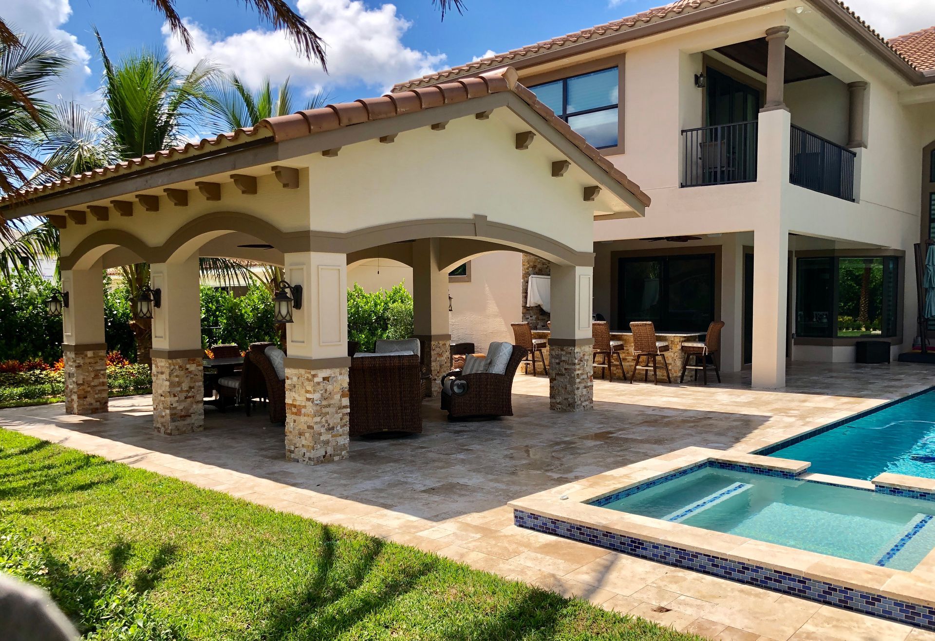 A large house with a swimming pool in front of it