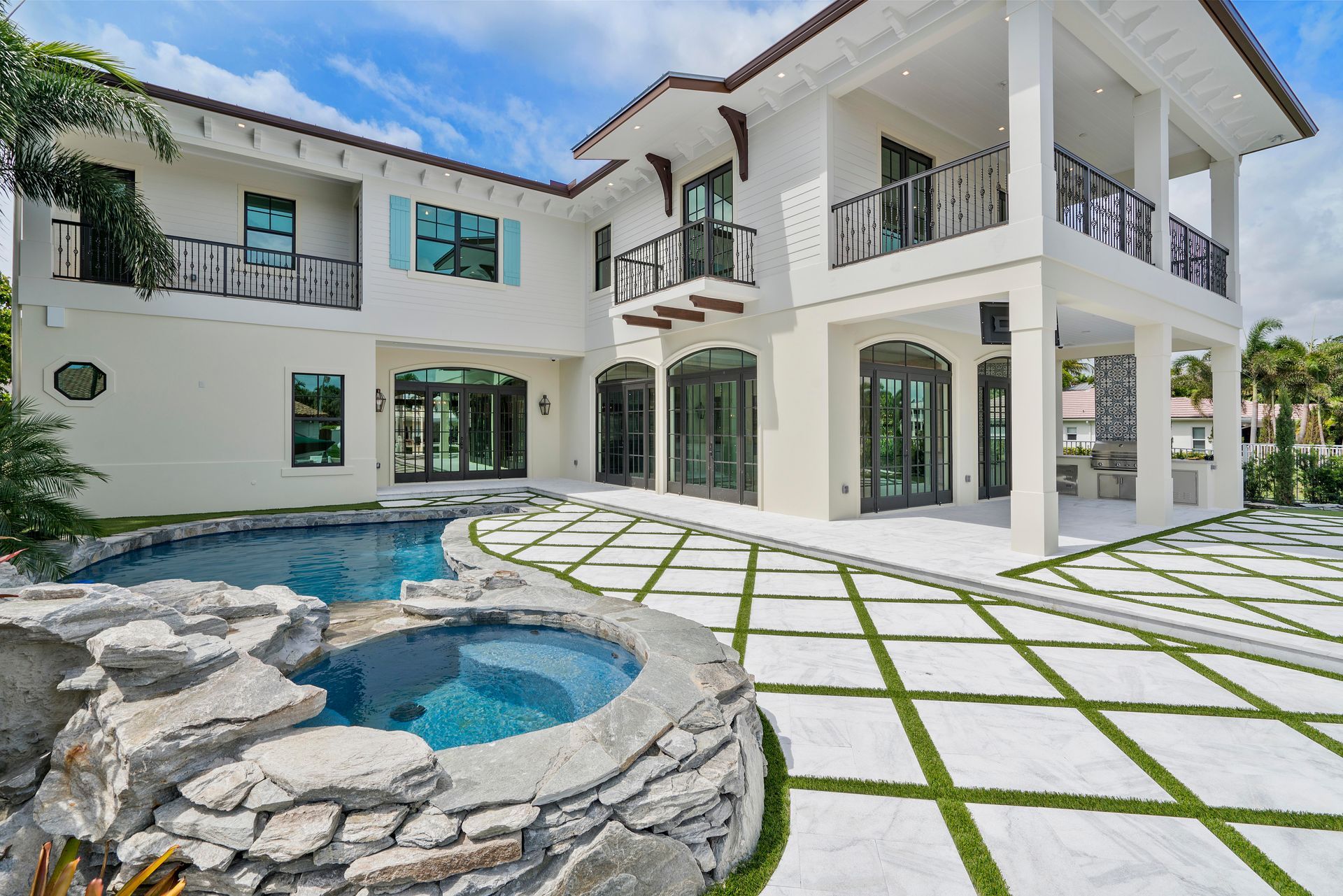 A large white house with a swimming pool in front of it