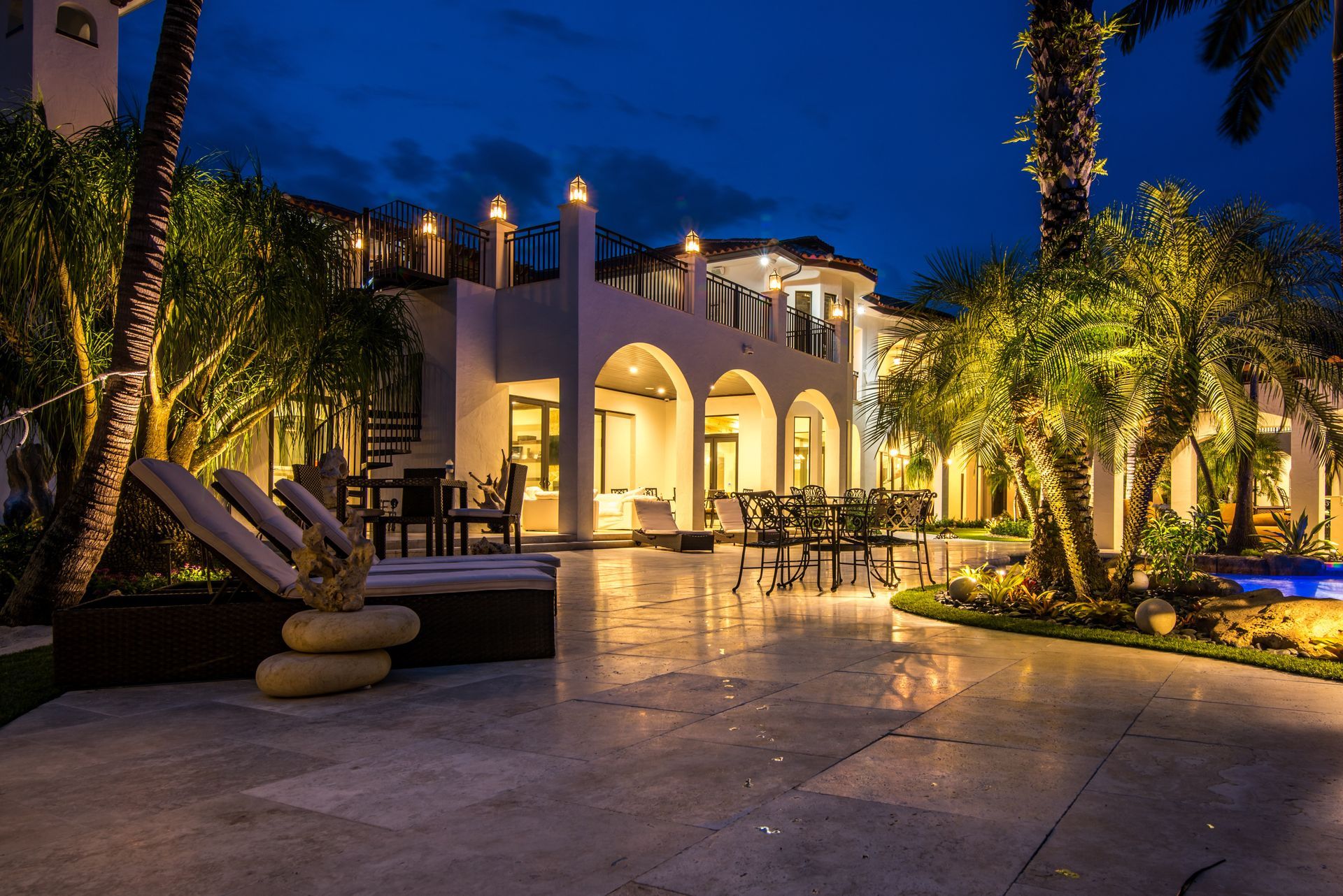 A large white house is lit up at night