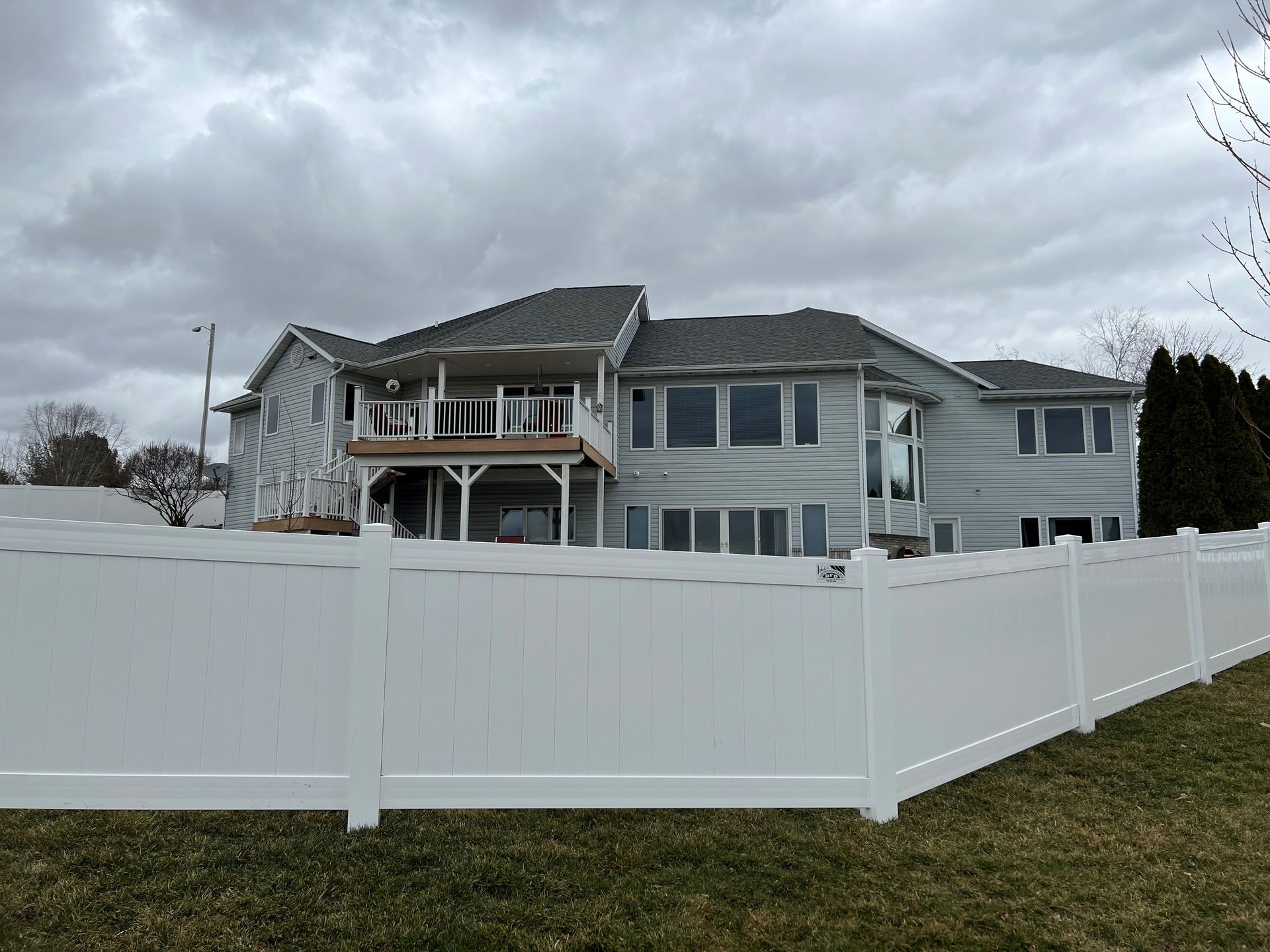 A large house with a white fence in front of it
