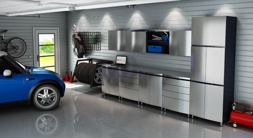Blue car in a modern garage with stainless steel cabinets and a work surface; includes storage and a bike.