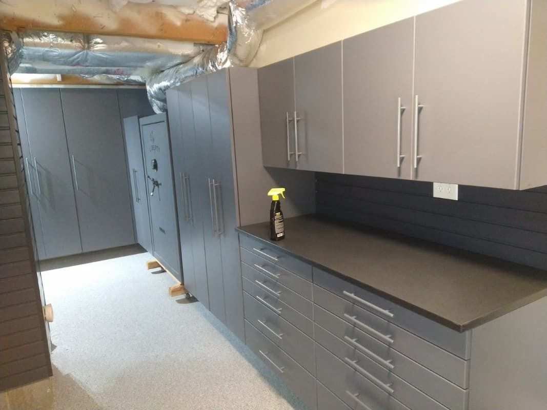 Gray cabinets and countertop in a basement storage space.