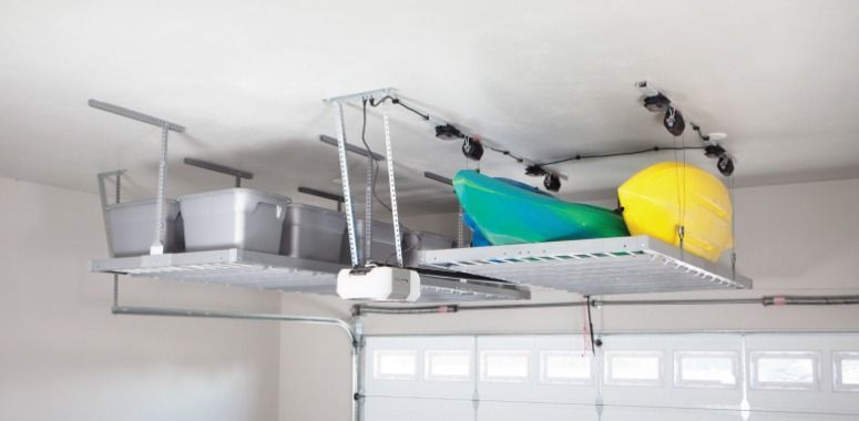 Overhead garage storage system with bins, kayak, and yellow item.