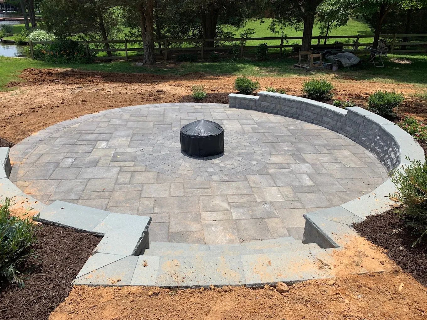 There is a fire pit in the middle of the patio.