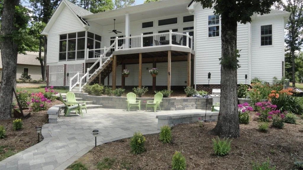 A white house with a patio and chairs in front of it