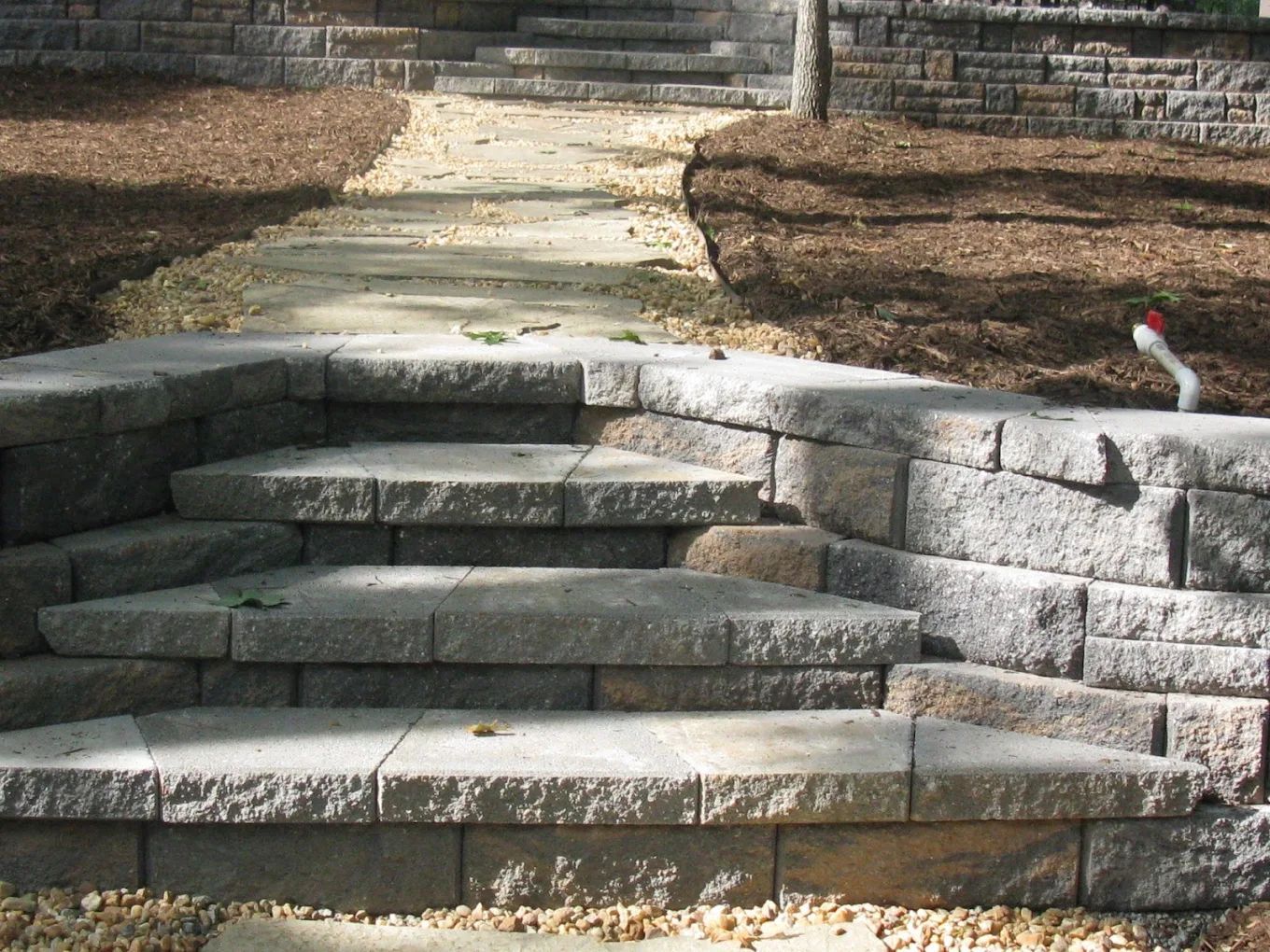 A set of stairs leading up to a stone wall