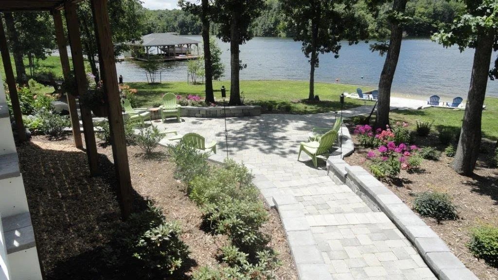 A walkway leading to a lake surrounded by trees