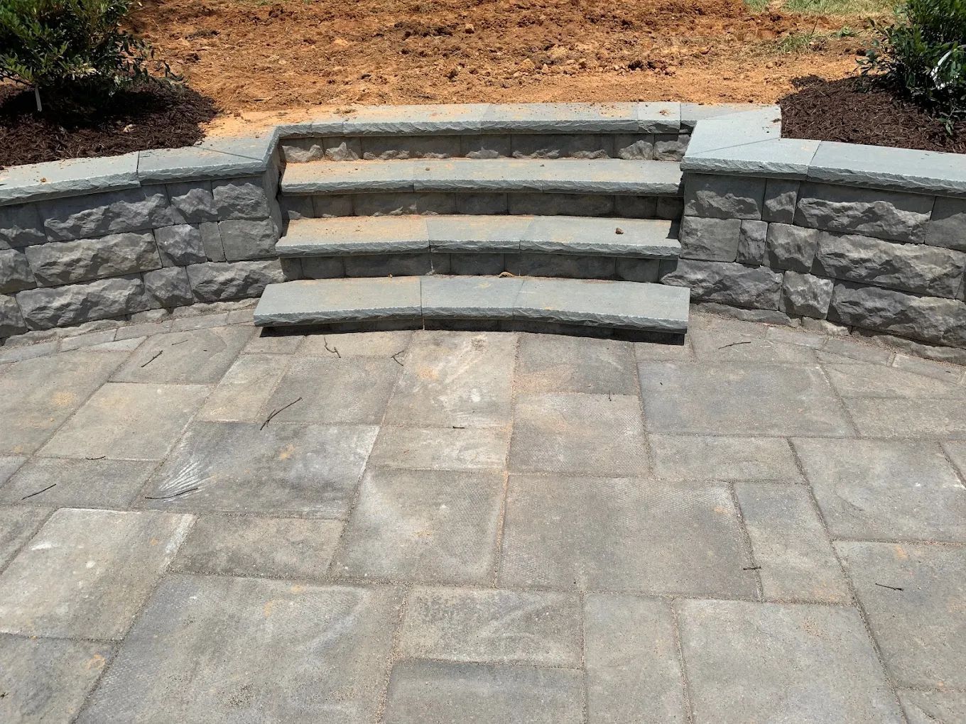 A set of stairs leading up to a stone wall
