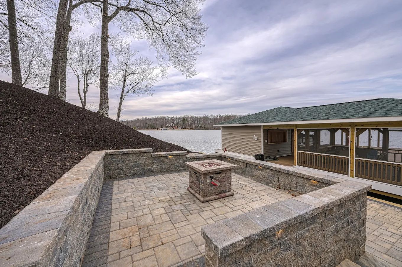 There is a fire pit in the middle of the patio.