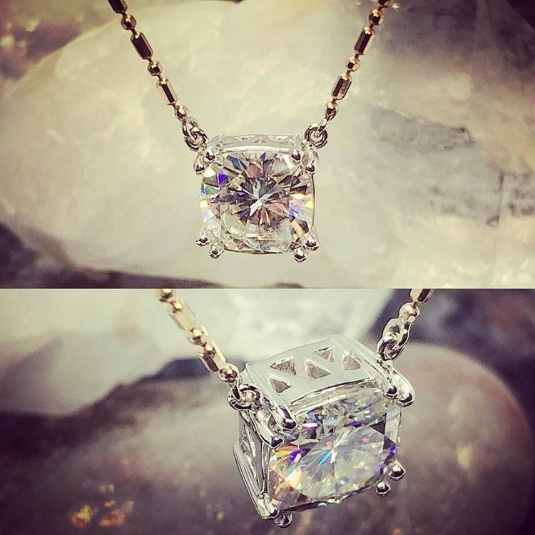 Crystal pendant necklace with a faceted square gem, shown in close-up against a soft blurred background
