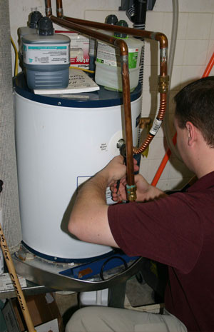 Repairman installing a water heater