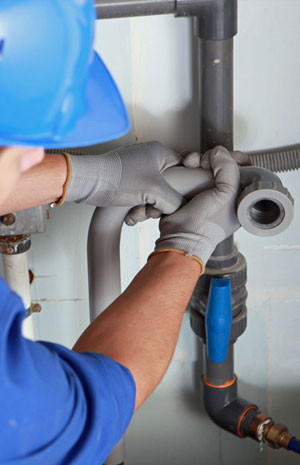 Repairman fixing a pipe connection