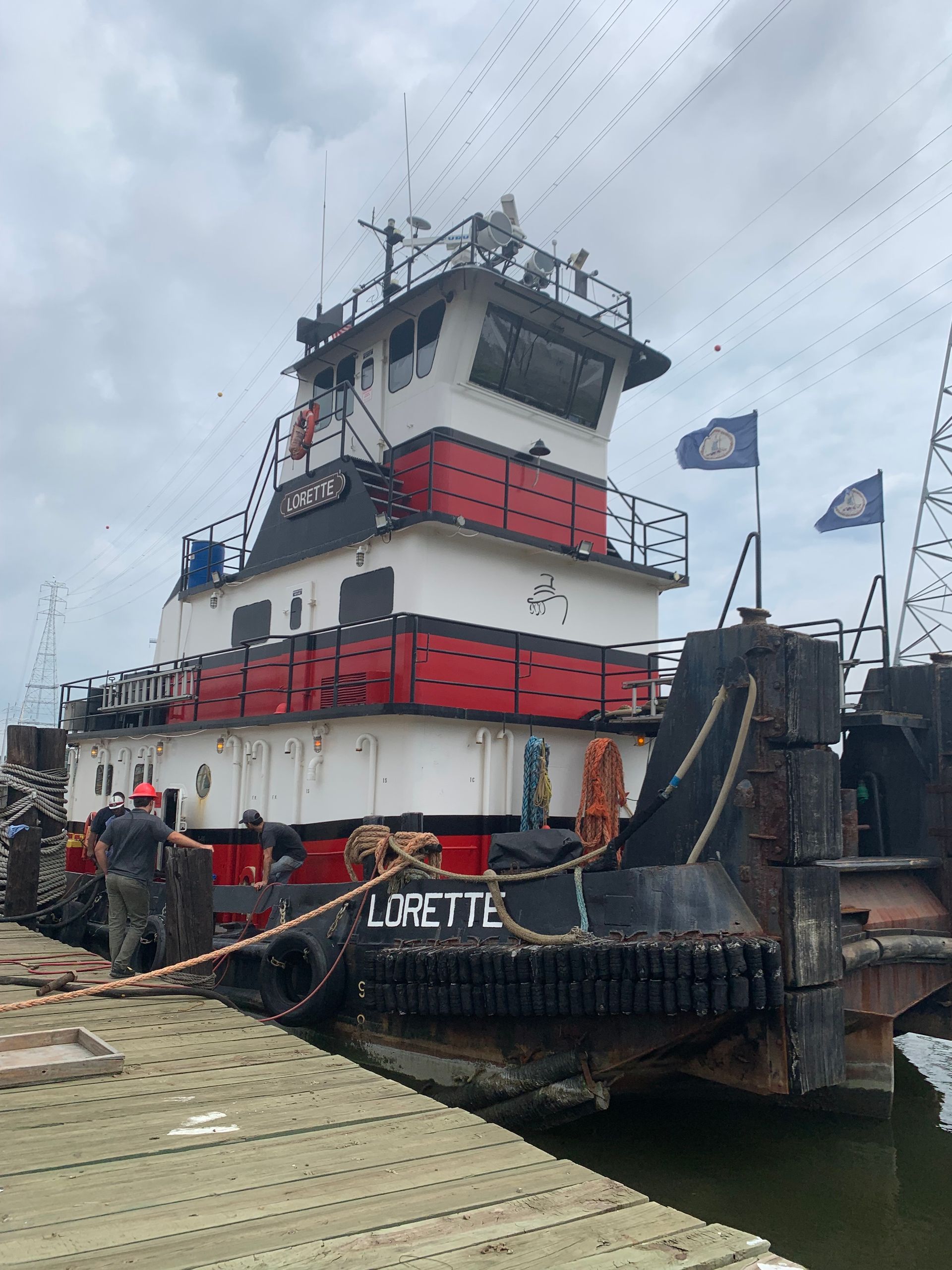 A large red and white boat is docked at a dock.