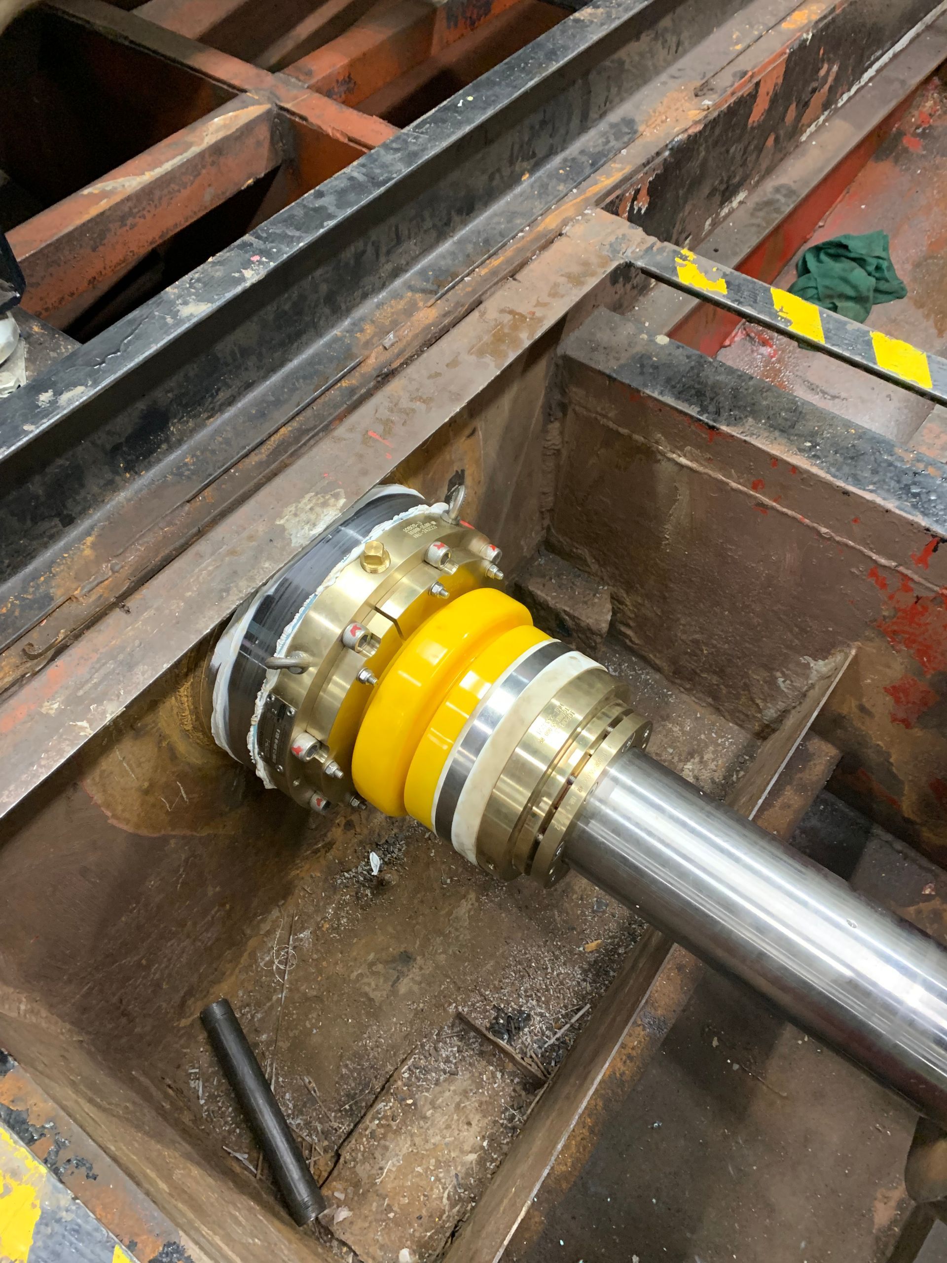 A close up of a metal pipe with a yellow ring on it.