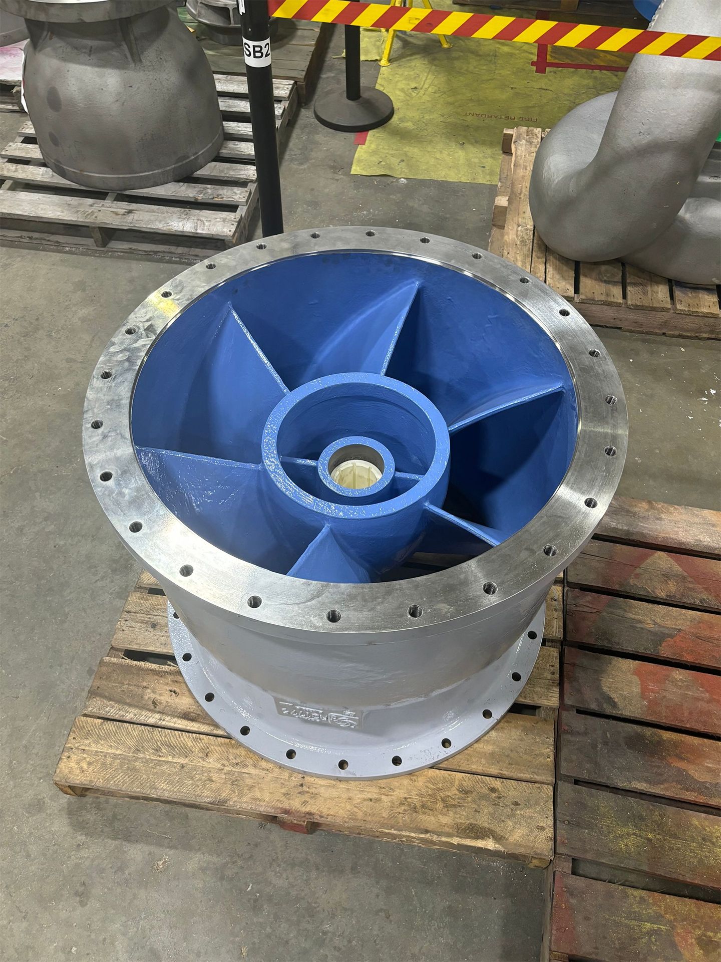 A large metal object is sitting on top of a wooden pallet