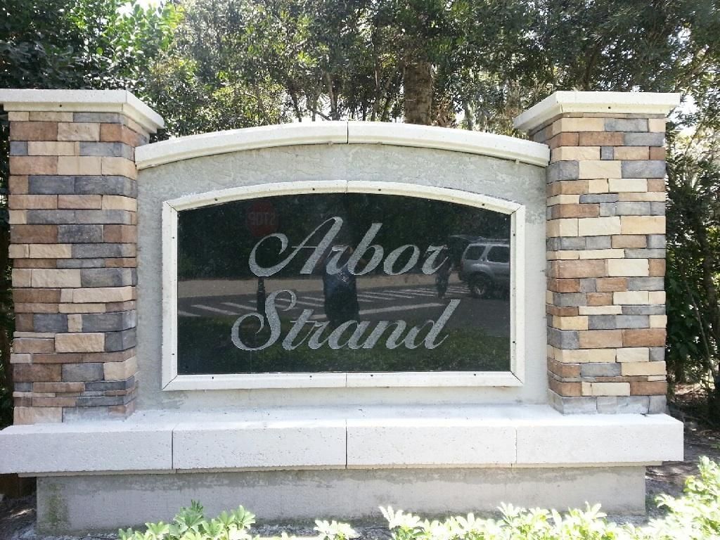 Stone sign reading “Aboi Strata” between brick pillars