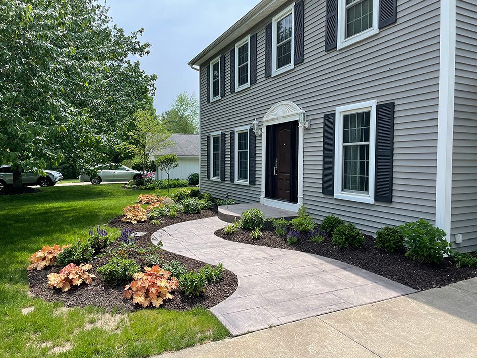 A large house with a walkway leading to the front door.