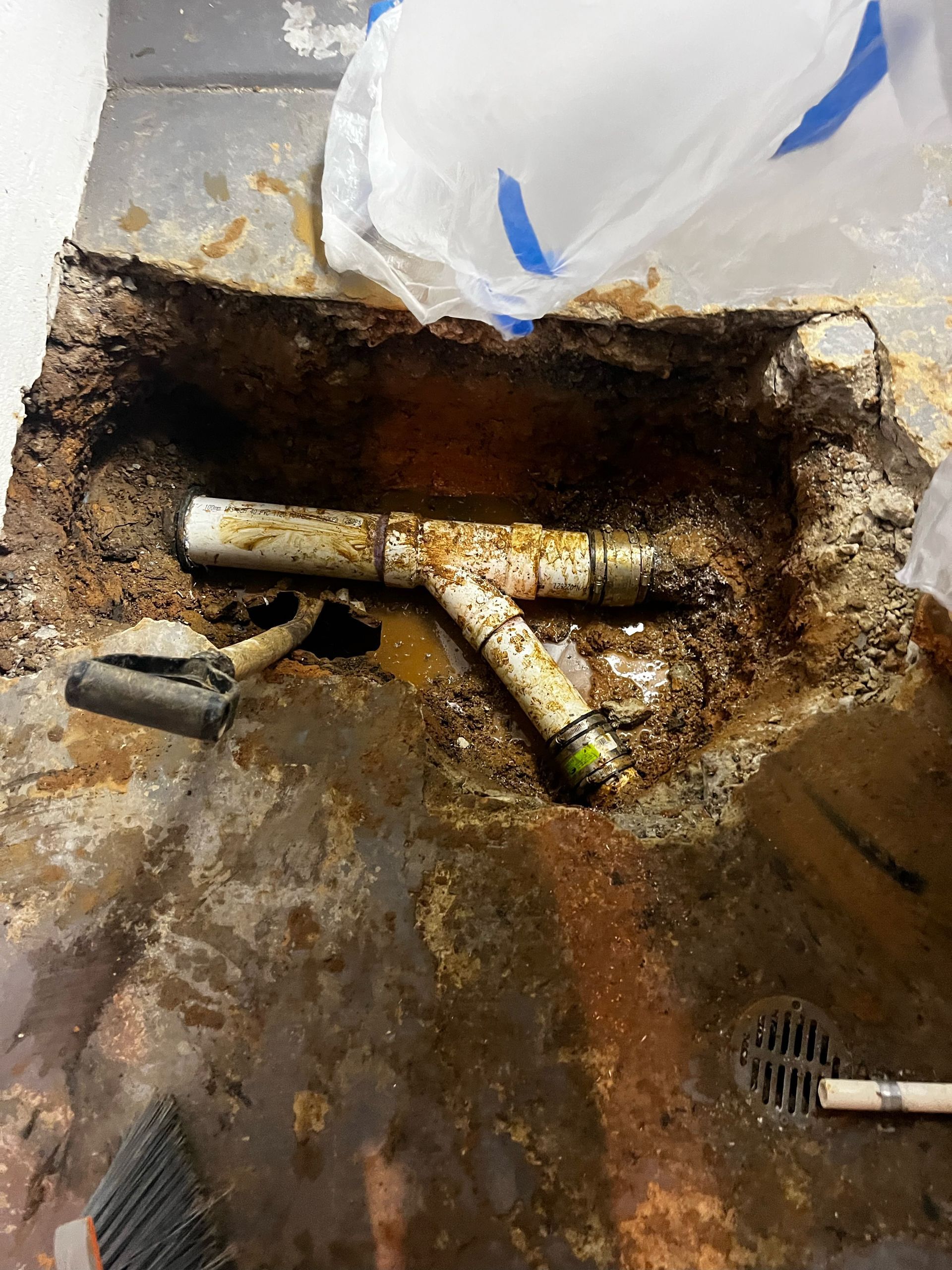 A hole in the ground with a pipe in it