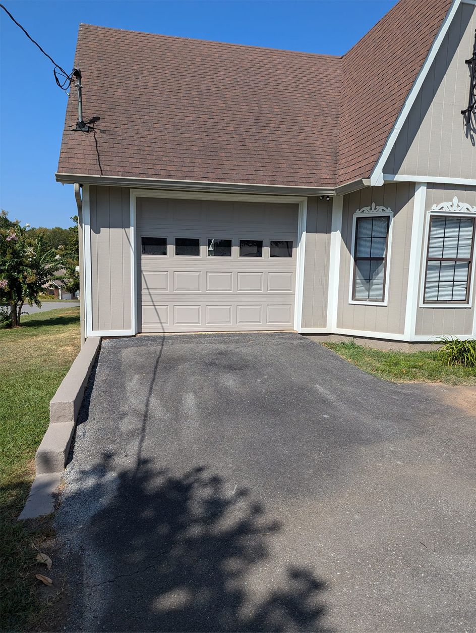 A house with a garage and a driveway in front of it