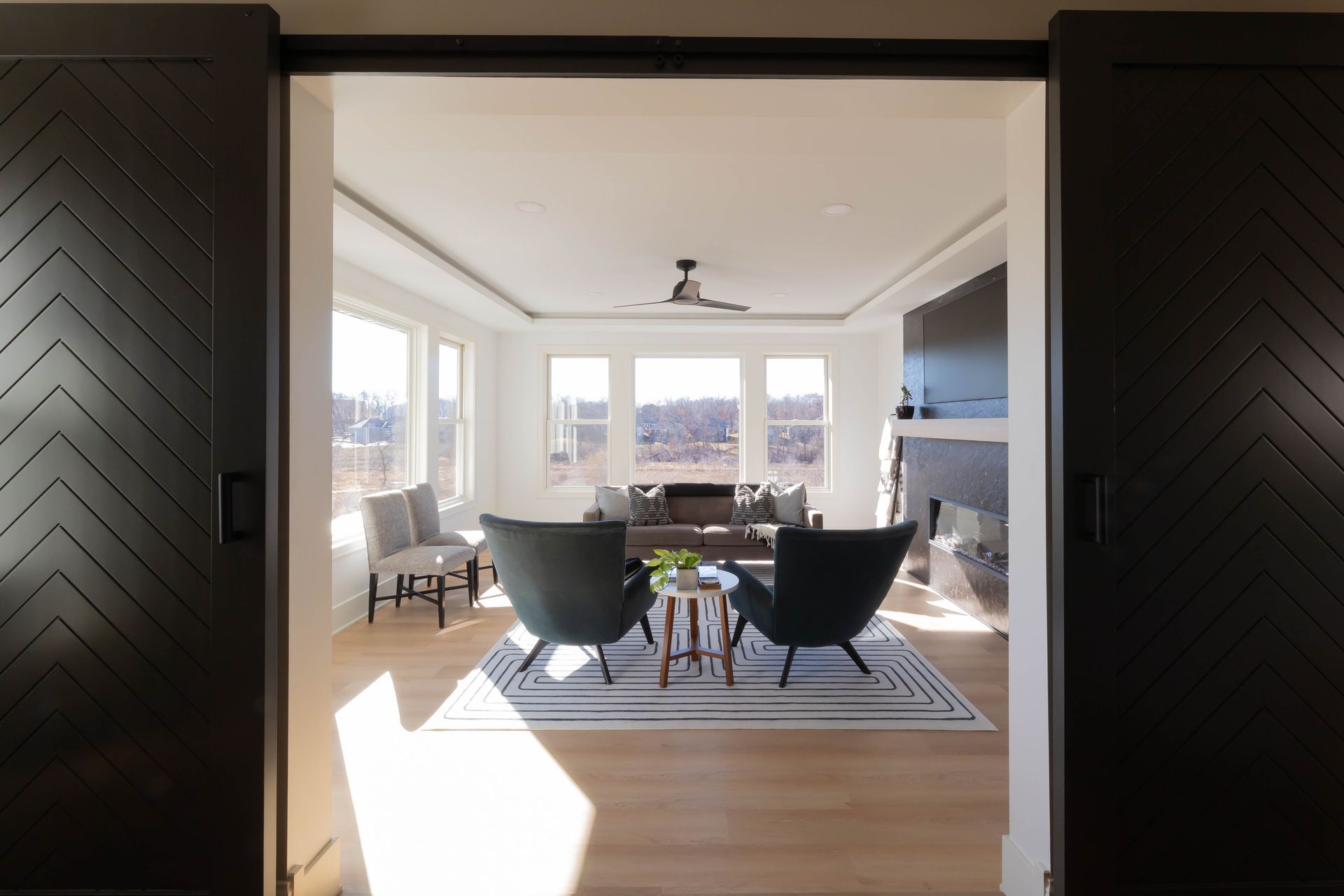 A sunroom with black chairs