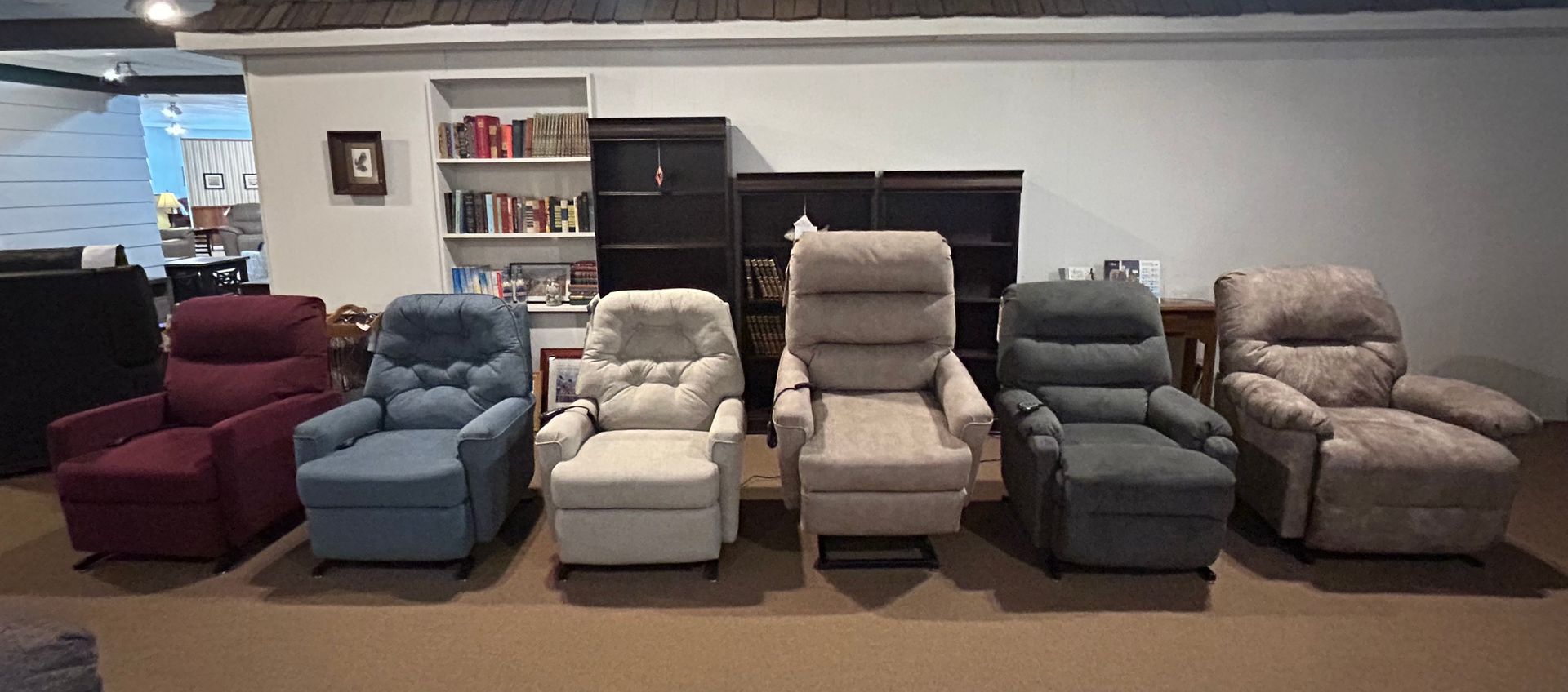 Living room with brown sectional sofa, large windows, and doors to an outdoor patio with umbrella and table.