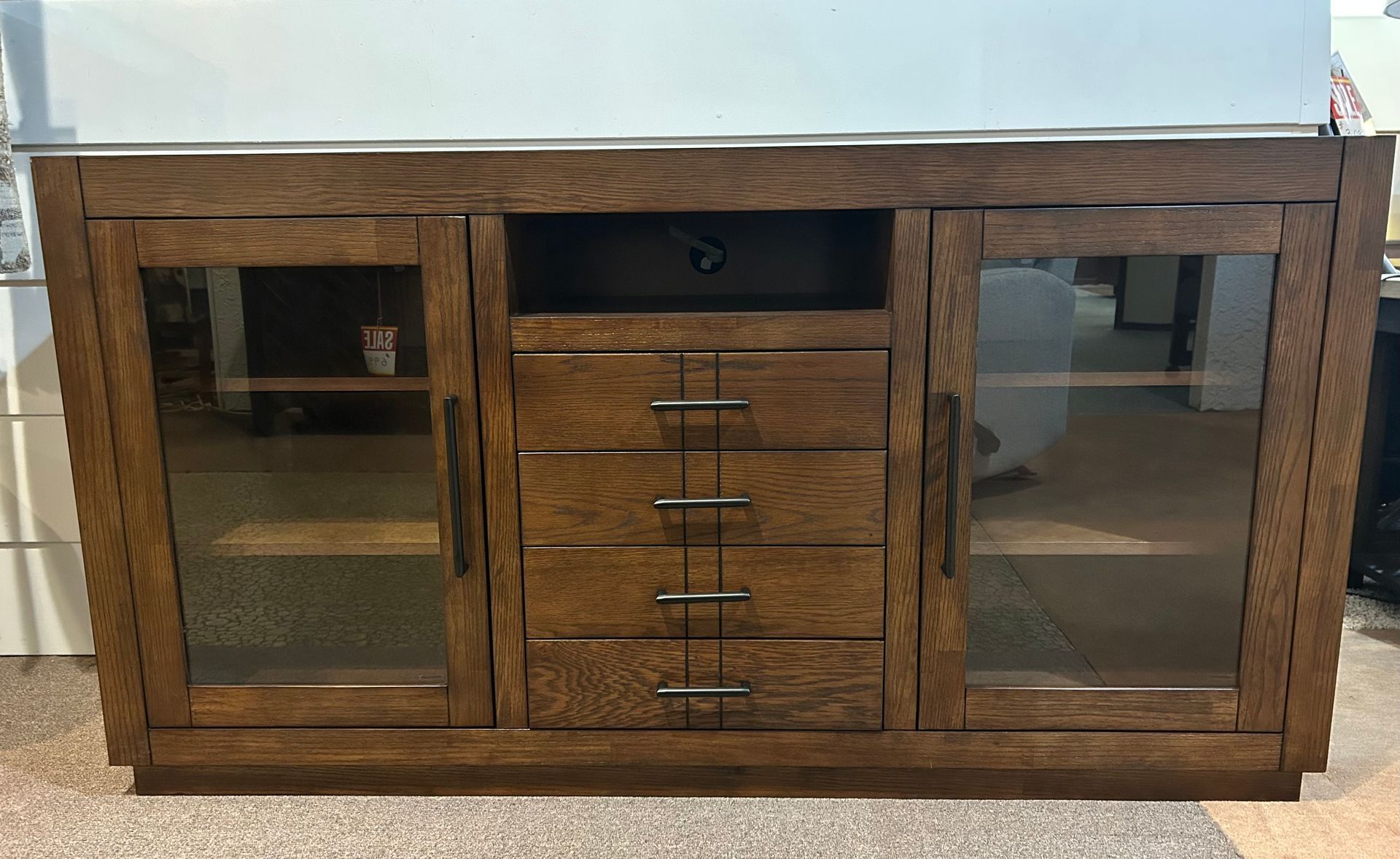 Wooden media console with glass-fronted doors and drawers. Dark brown finish.