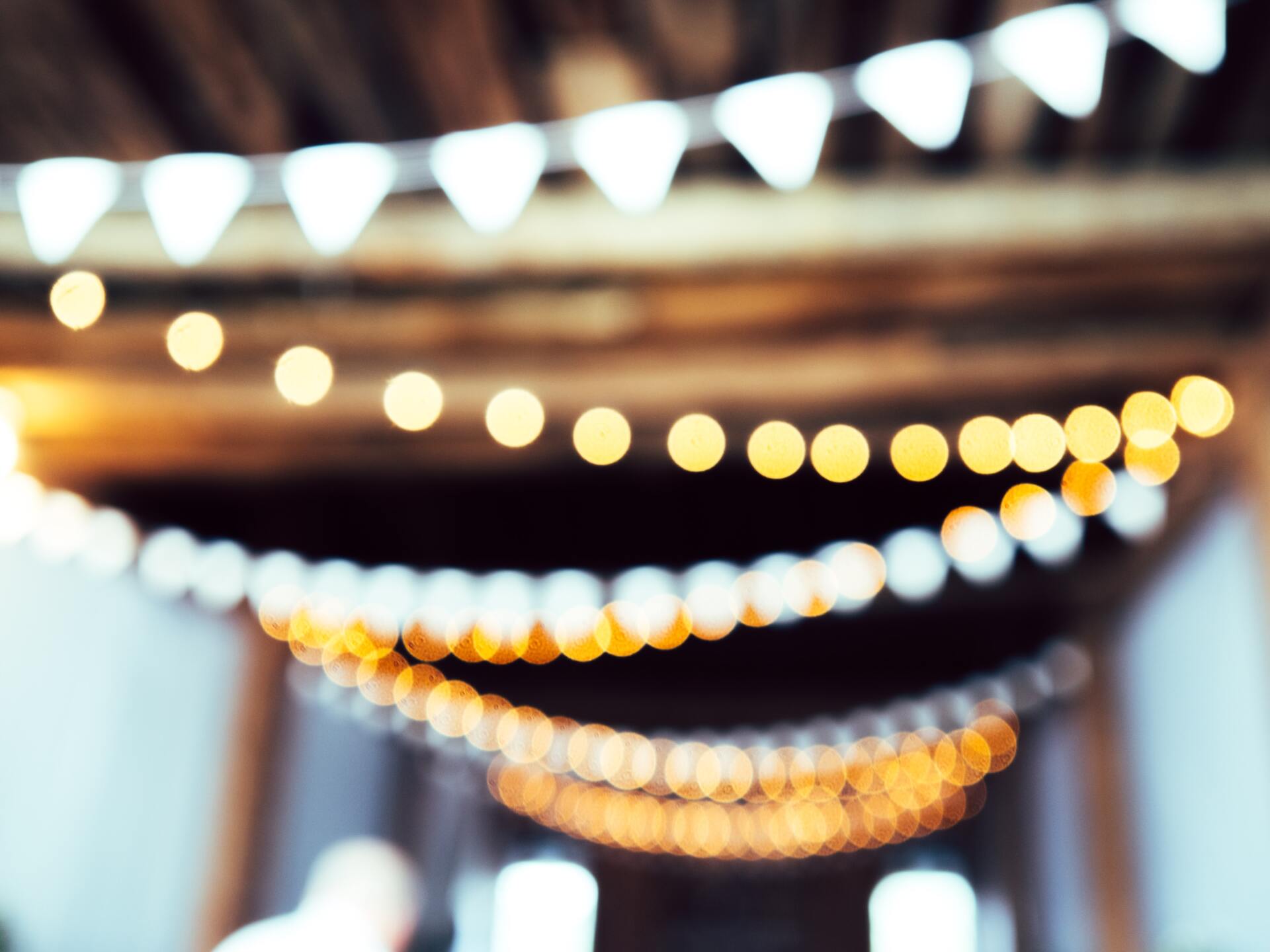 A blurry picture of a string of lights hanging from the ceiling.