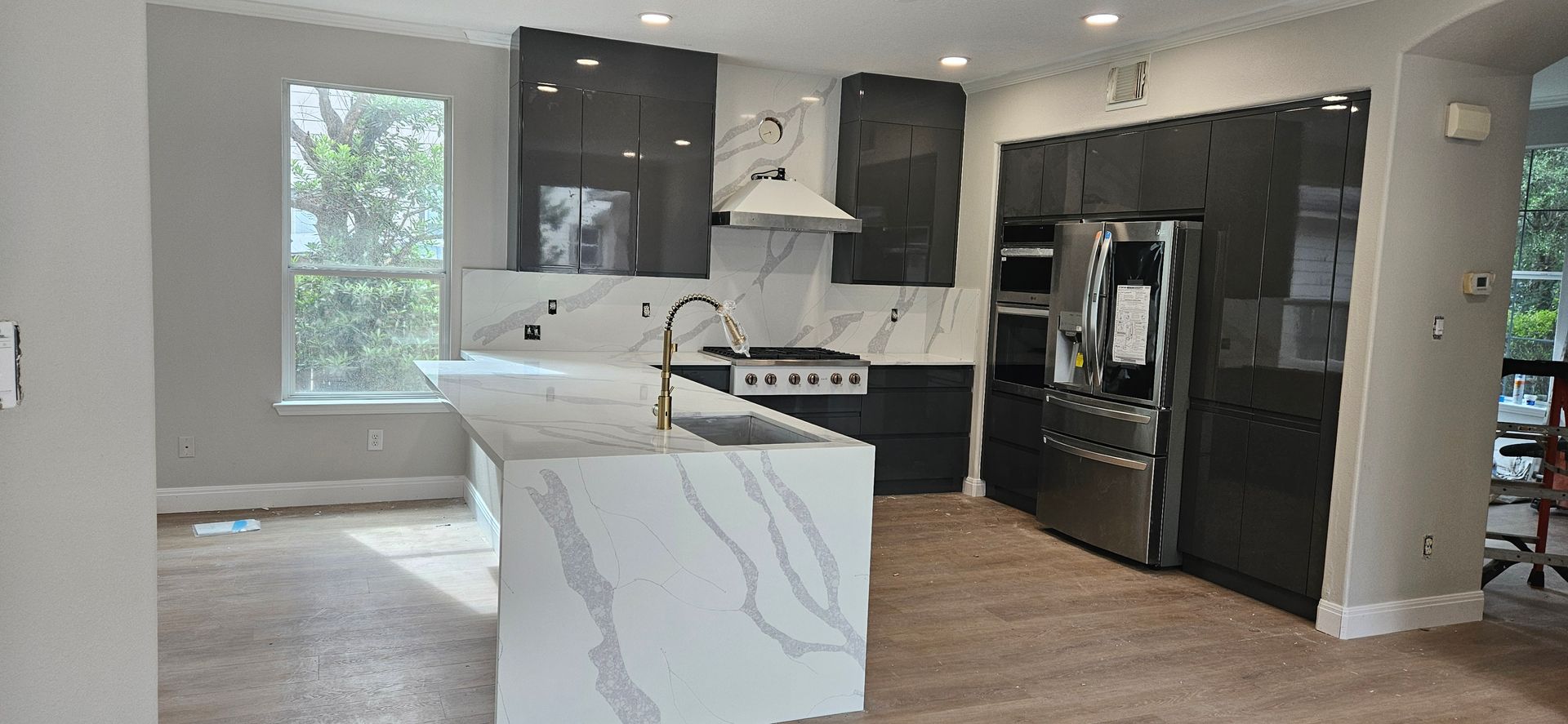 A kitchen with a large island and stainless steel appliances.