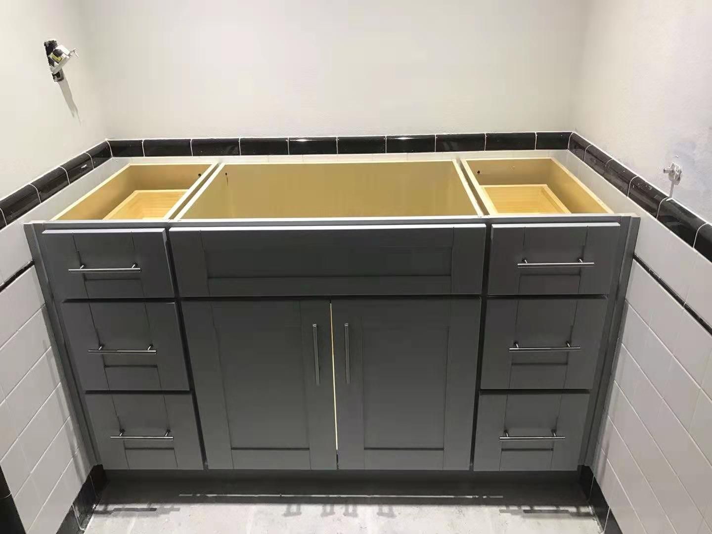 A bathroom vanity with a sink and drawers underneath it.