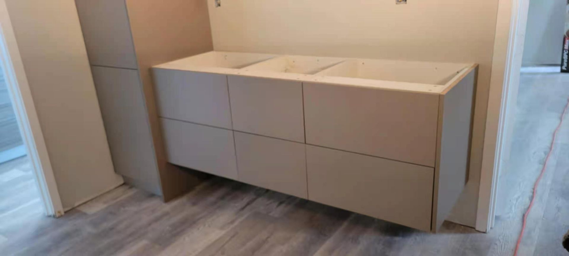 A bathroom vanity is being built in a room.