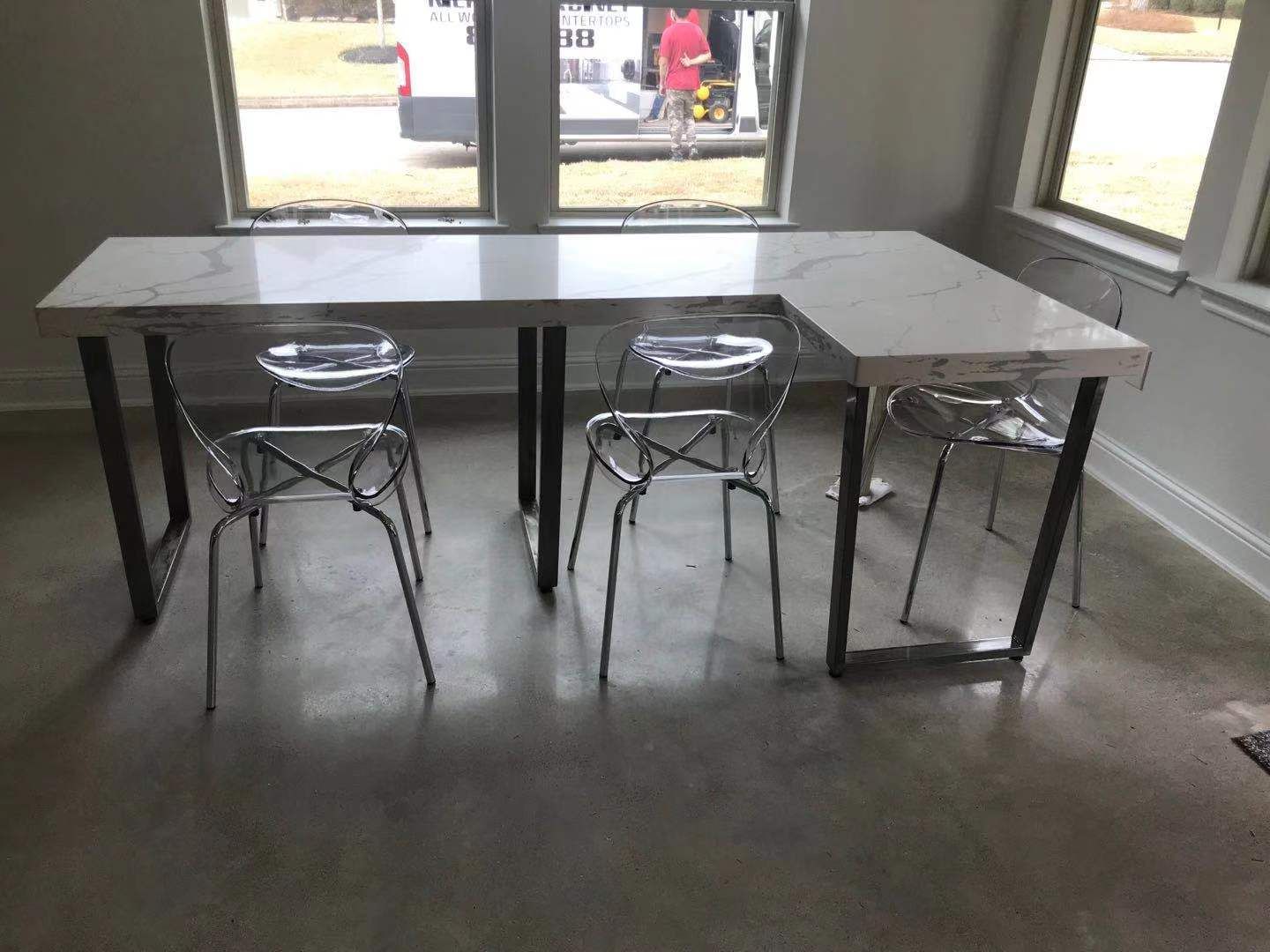 A room with a table and chairs in it.