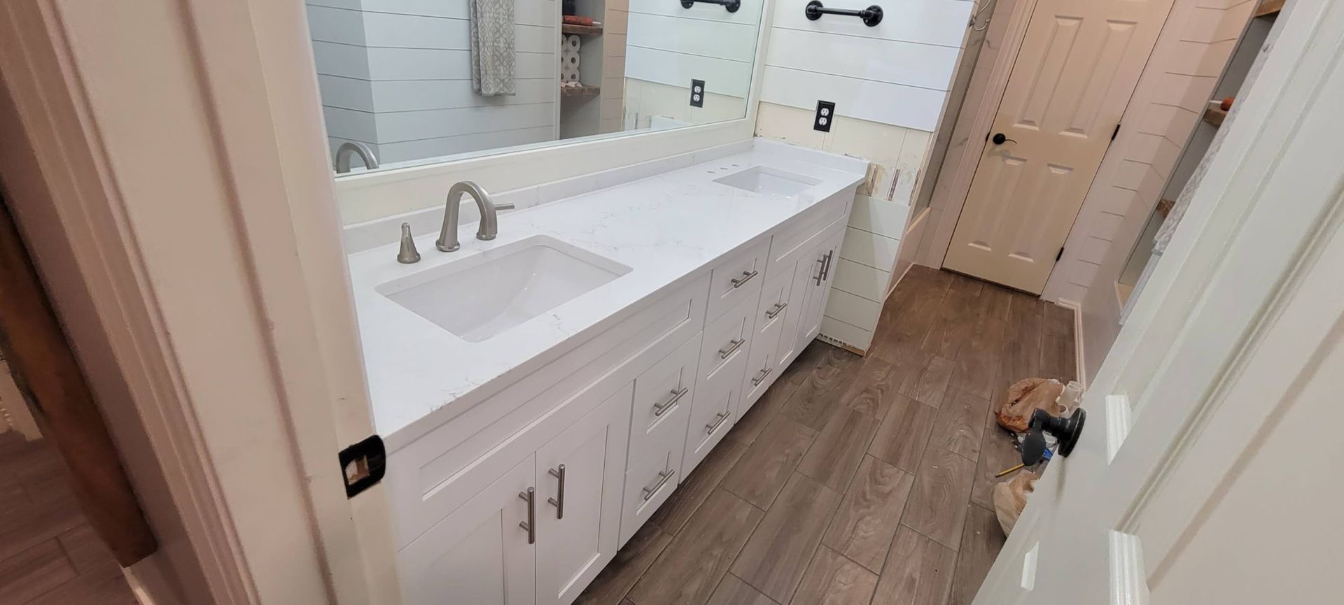 A bathroom with two sinks and a large mirror.