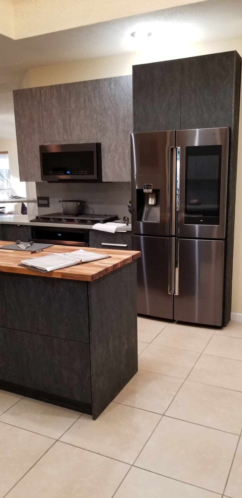 A kitchen with stainless steel appliances and a large island.
