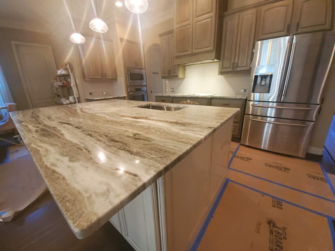 A kitchen with granite counter tops and stainless steel appliances.
