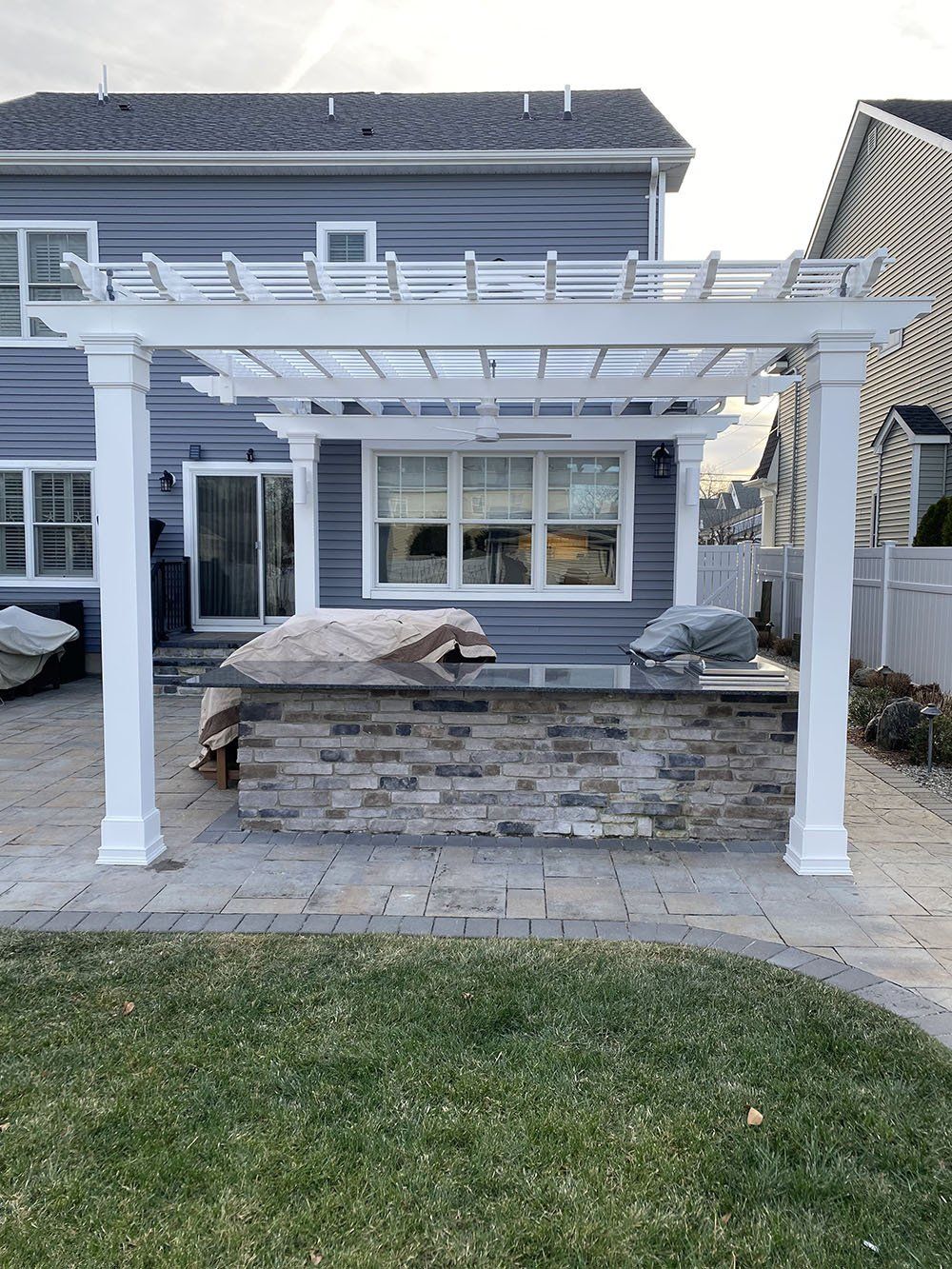 White arbor and house