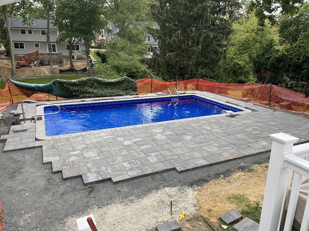 Blue swimming pool with gray stone