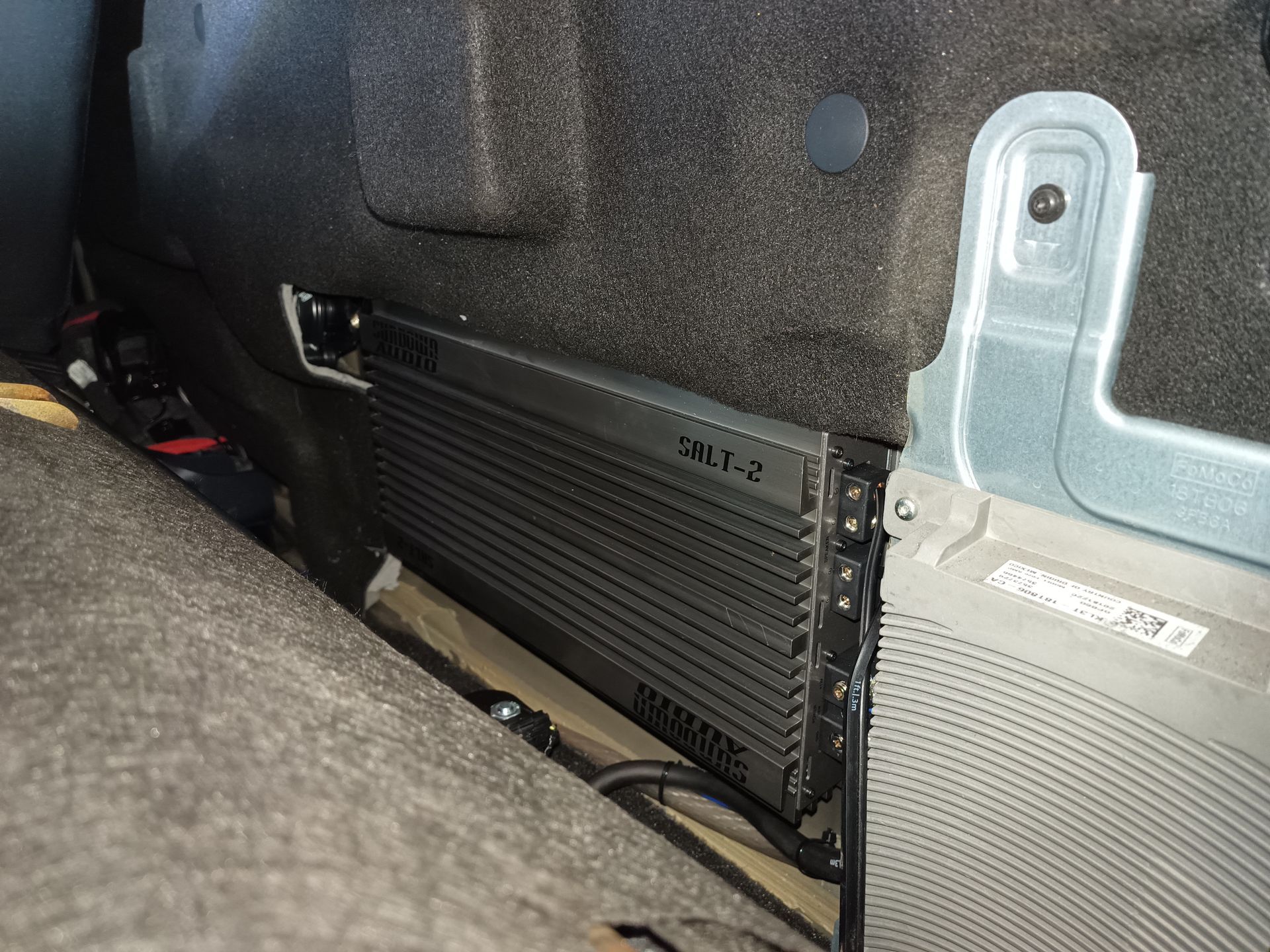 Black car amplifier labeled 