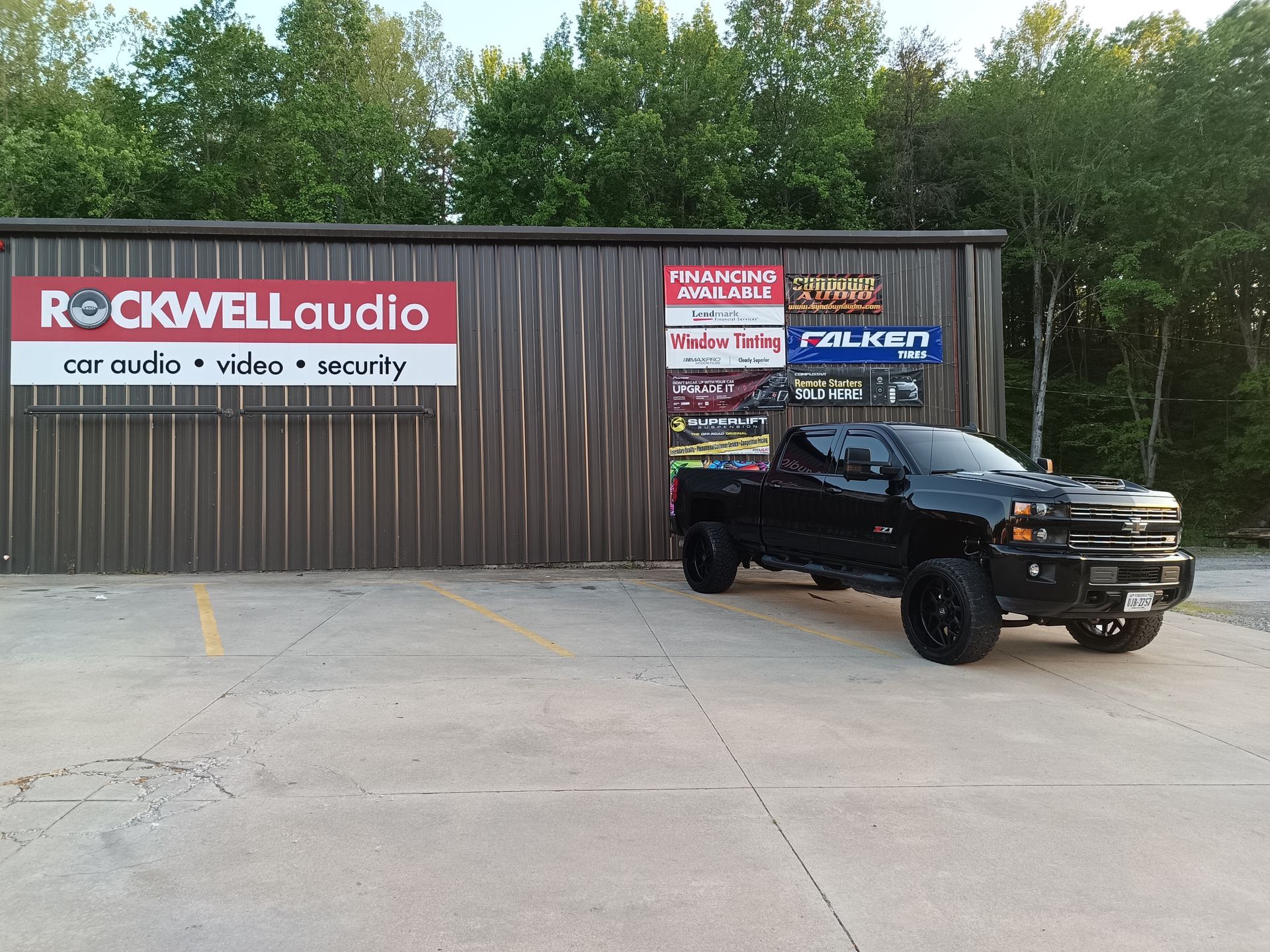 Black truck parked outside a building with 