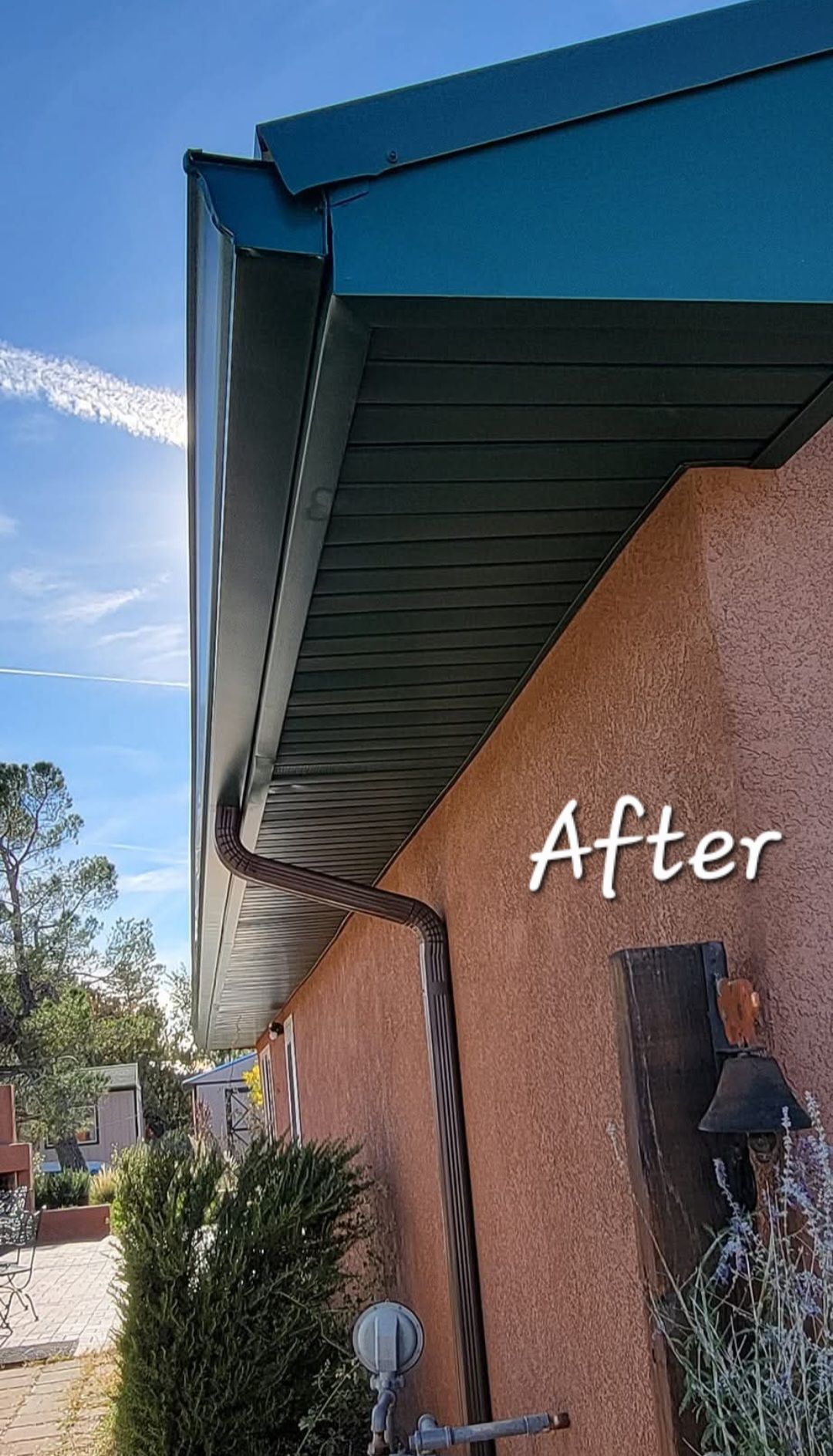 Blue roof eaves over tan stucco wall with “After” text and a small lantern on the side of a house