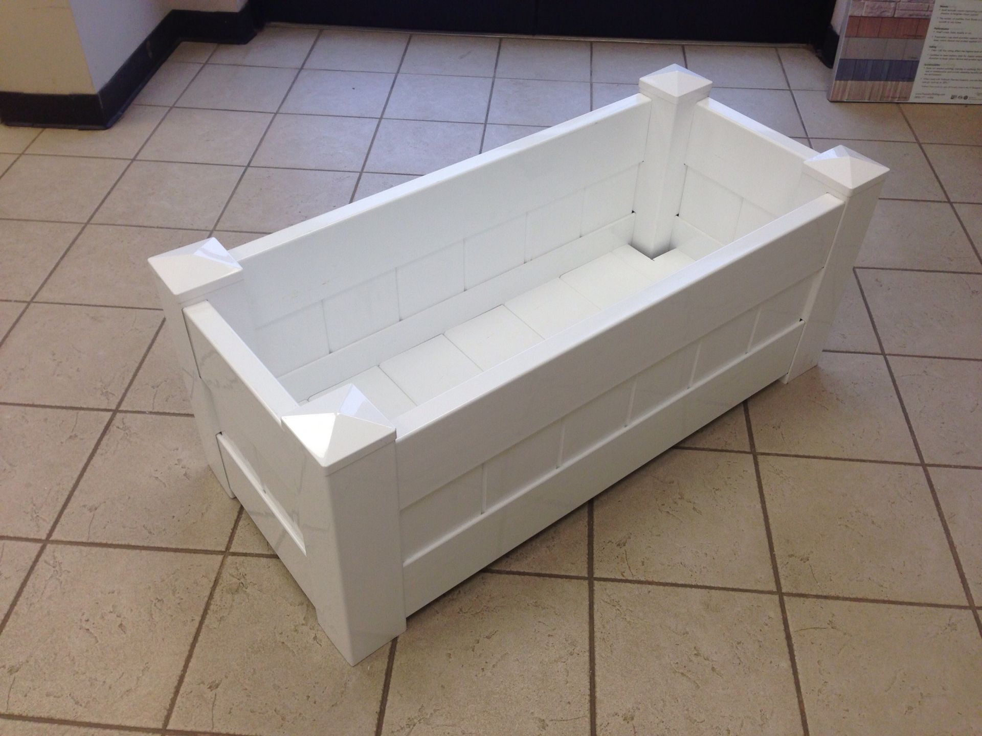 A white bathtub is sitting on a tiled floor
