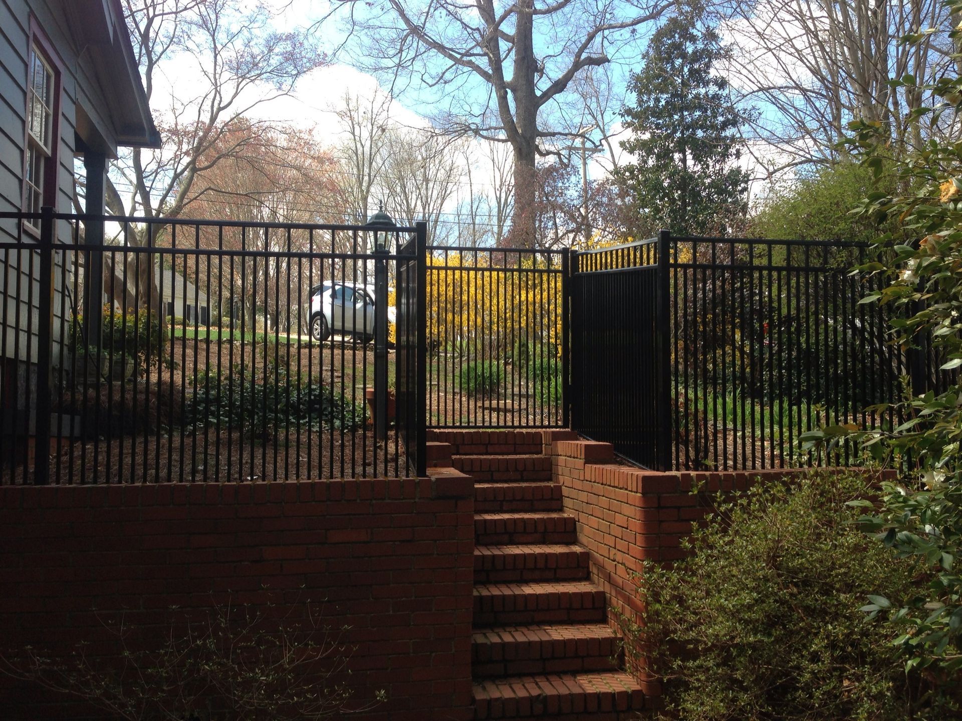 A black fence with stairs leading up to it