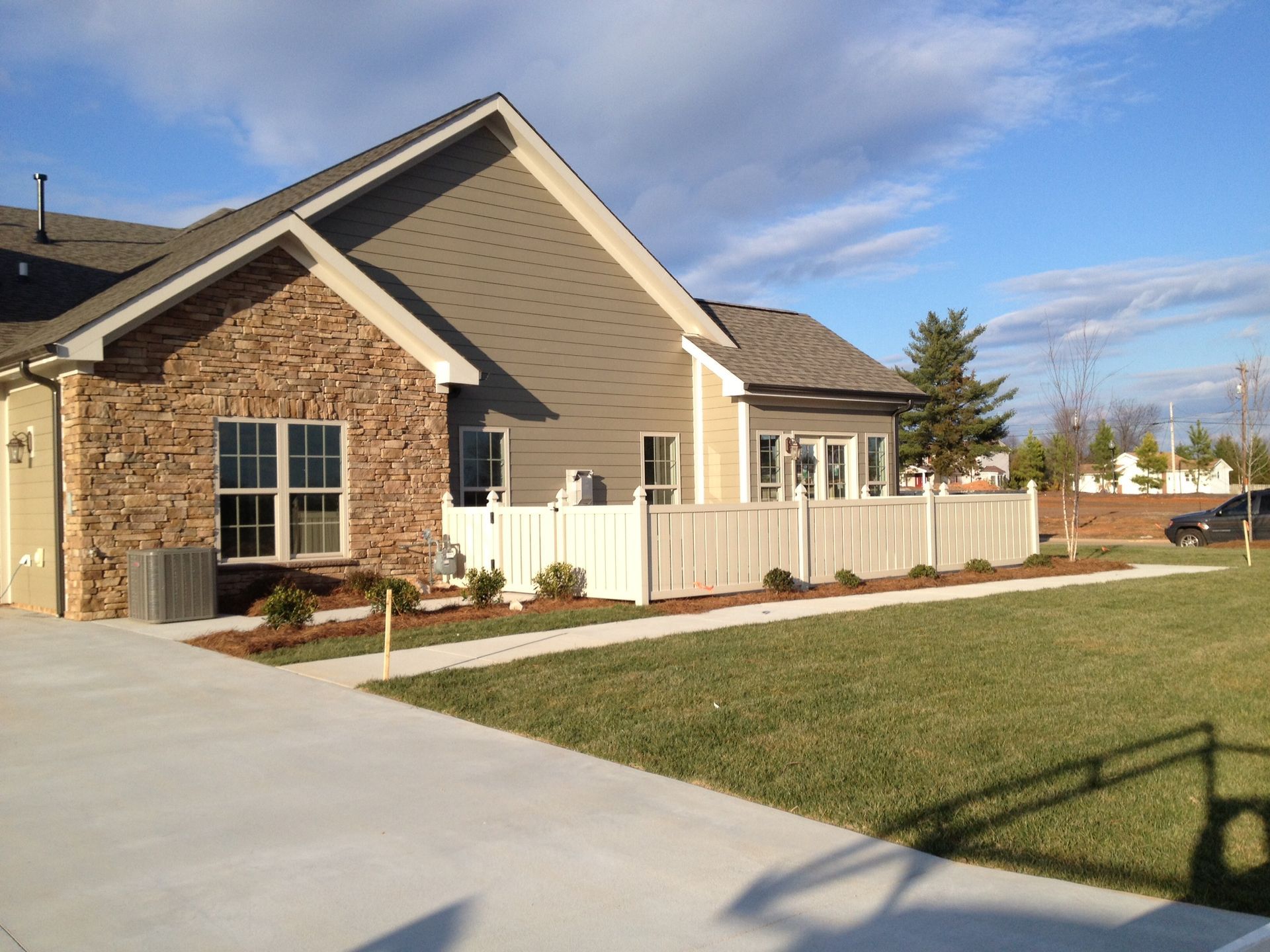 A house with a white fence in front of it