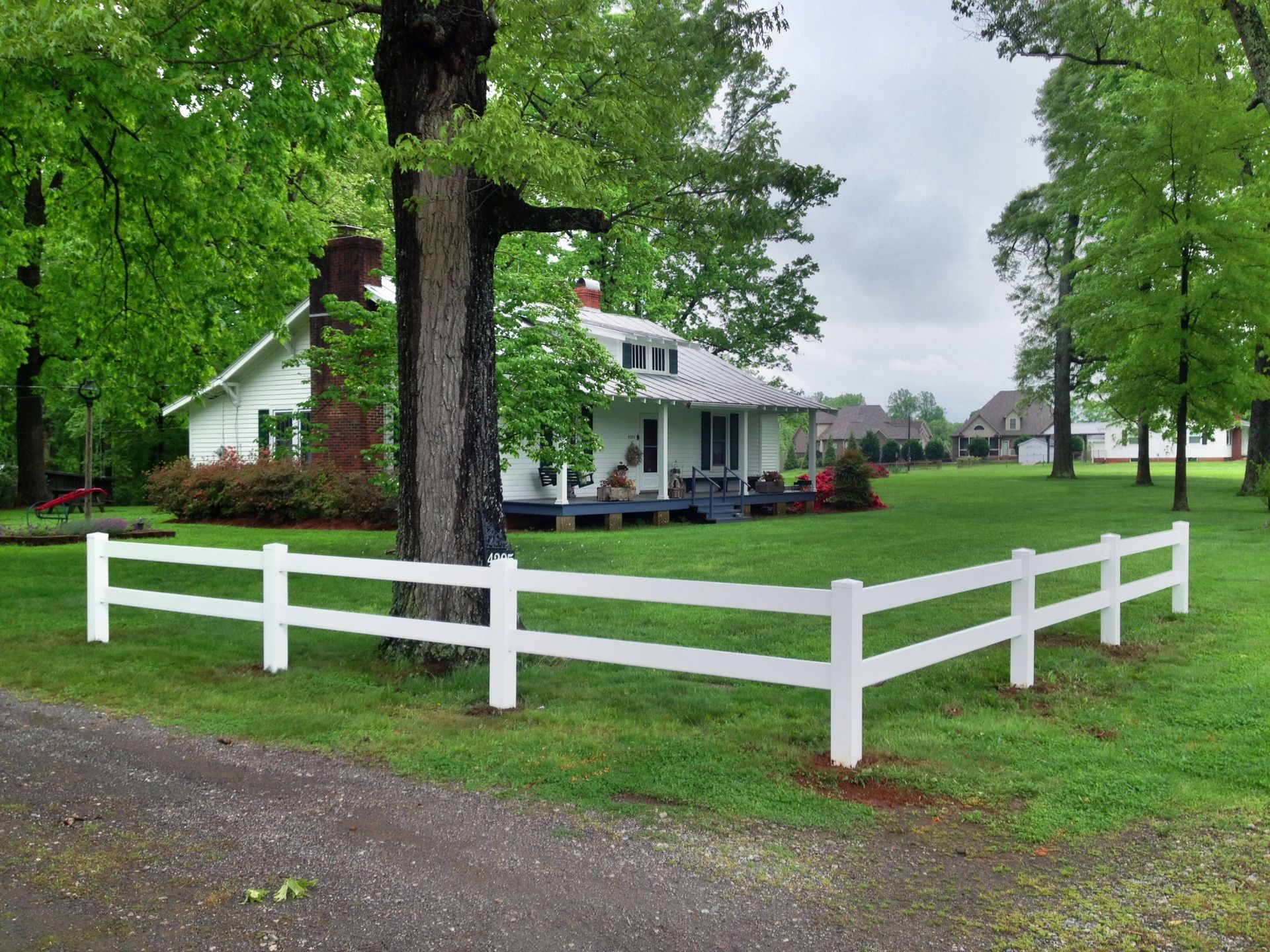 A white house with a white fence in front of it
